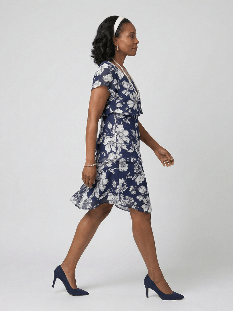 Thea™ floral knee-length dress by Emma & Rose Cape Town featuring a fitted bodice and flowing skirt with vibrant floral print.