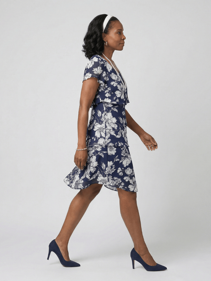 Thea™ floral knee-length dress by Emma & Rose Cape Town featuring a fitted bodice and flowing skirt with vibrant floral print.