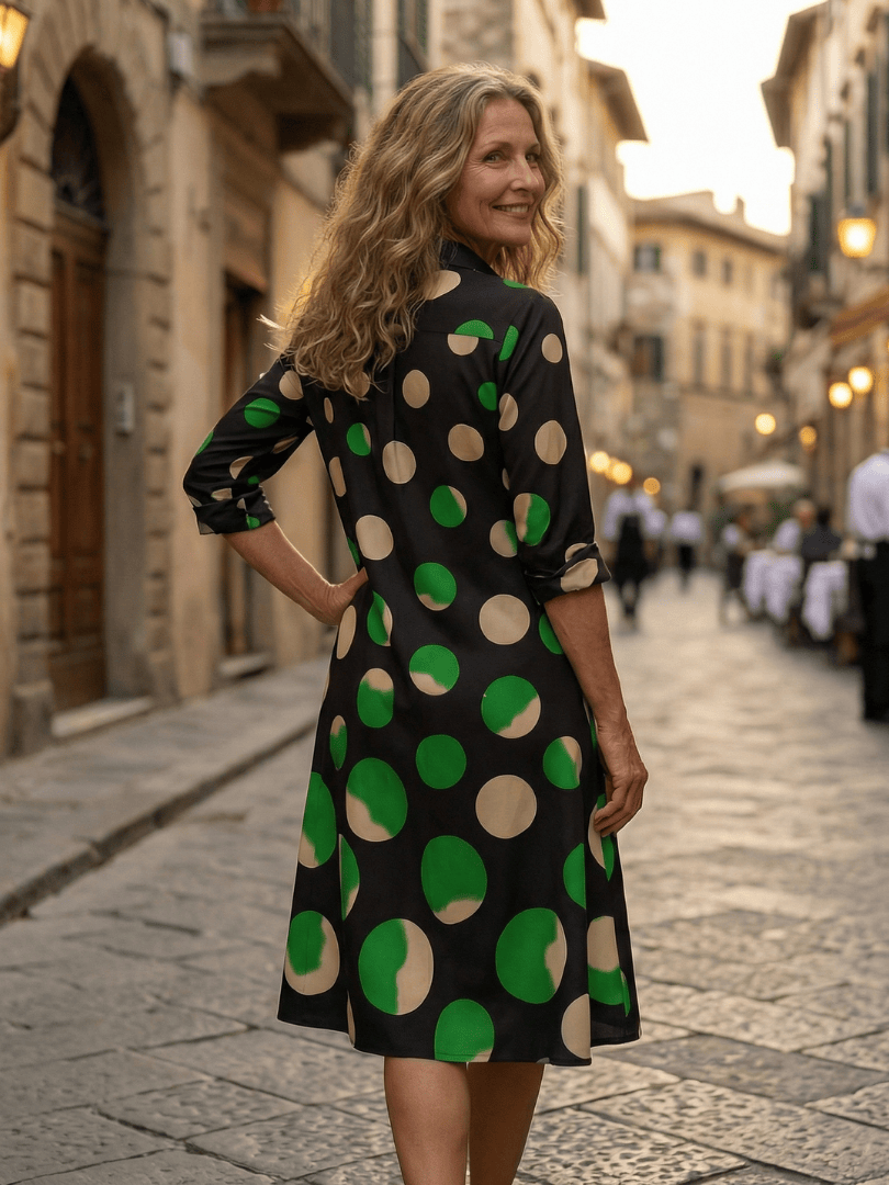 Kaia™ Dinner Walk Dress by Emma & Rose Cape Town, elegant navy dress with floral pattern and short sleeves, hanging on a hanger.