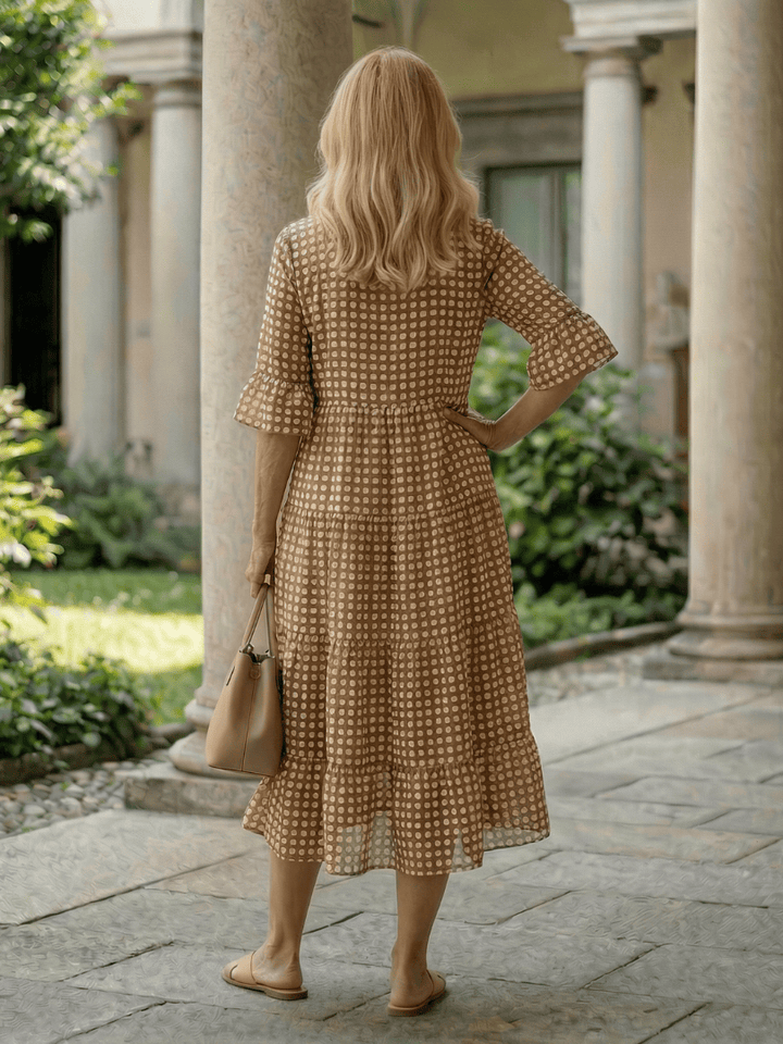 Emma & Rose Cape Town Arlo™ Dot Tiered Midi Dress featuring a playful dot pattern and flowing tiered silhouette.