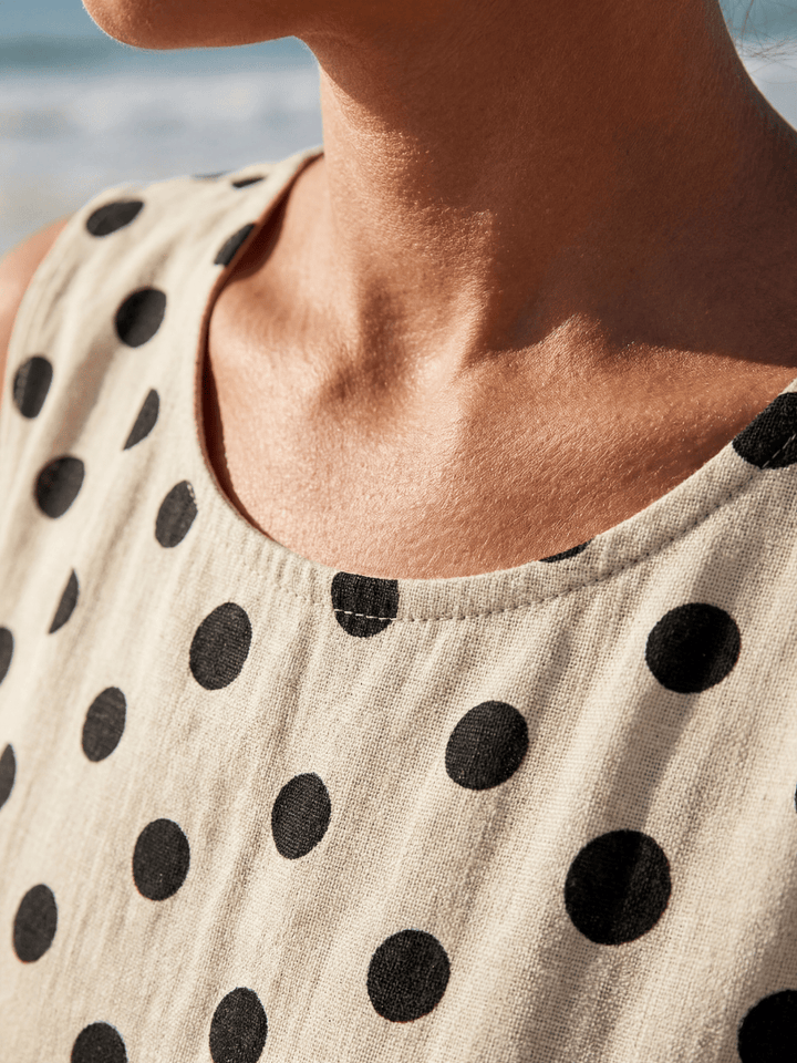 Hugo™ Garden Dot Midi Dress by Emma & Rose Cape Town displayed on a hanger with floral pattern and midi length.