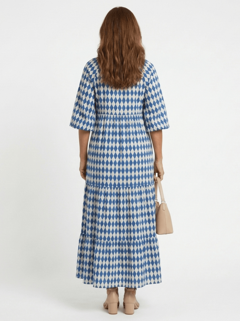 Elodie™ print tiered midi dress by Emma & Rose Cape Town, showcasing flowy fabric, tiered layers, and vibrant floral pattern.