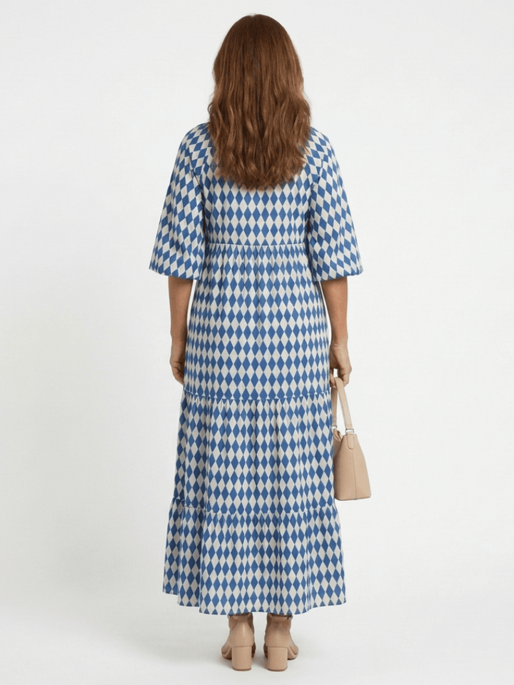 Elodie™ print tiered midi dress by Emma & Rose Cape Town, showcasing flowy fabric, tiered layers, and vibrant floral pattern.