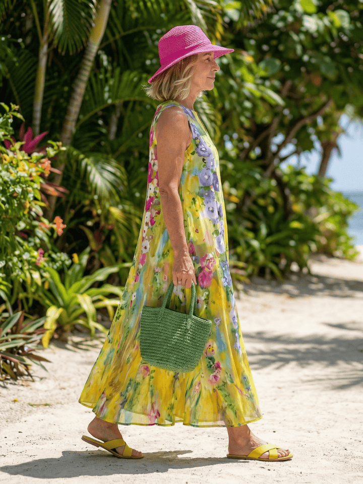 Emma & Rose Cape Town Avira™ Light Flow Maxi Dress with floral print, flowing fabric, and sleeveless design on a model.