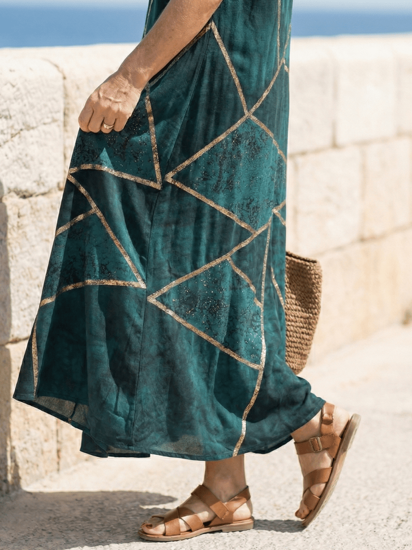 Saelle™ Calm Tide Midi Dress by Emma & Rose Cape Town, flowing fabric, soft blue tones, and elegant design on a model.