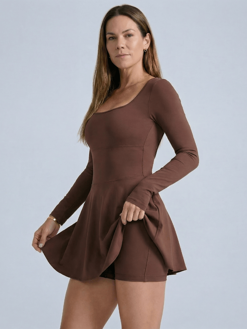 Emma & Rose Cape Town Blaire™ Core Skirt Tennis Dress shown on a model, featuring a fitted tennis dress with a skirt and athletic design.