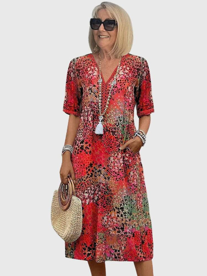 Elegant floral midi dress by Emma & Rose Cape Town featuring a flowing silhouette and detailed flower print.