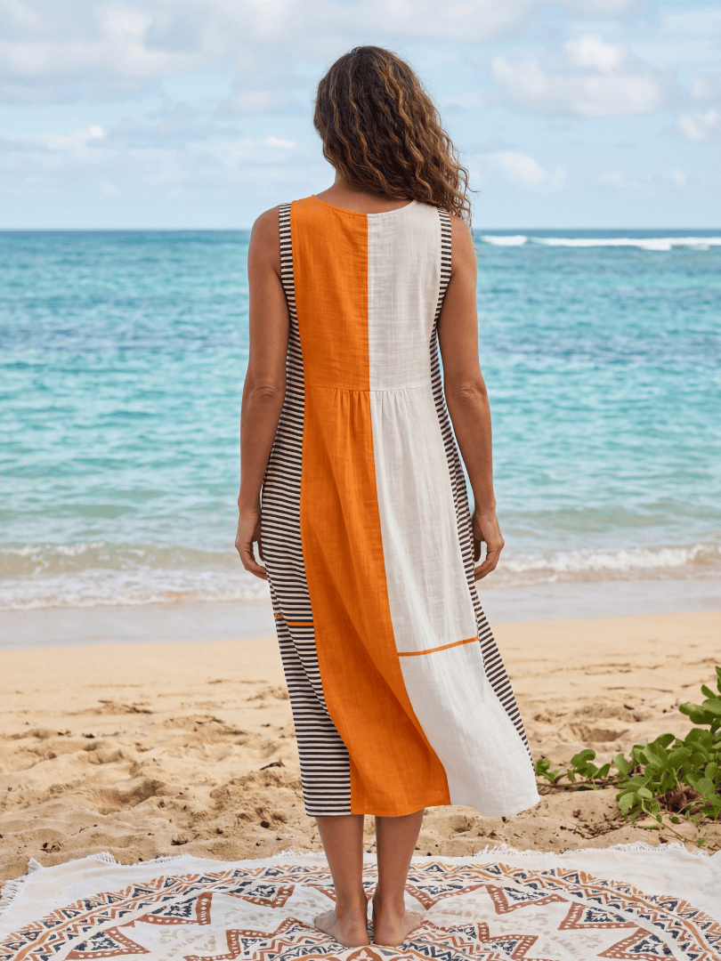 Owen™ Block Stripe Midi Dress by Emma & Rose Cape Town displayed on a mannequin with a flowing silhouette and vibrant stripe pattern.