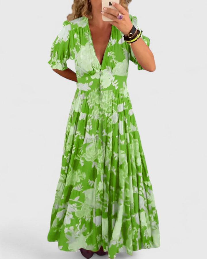 Emma & Rose Cape Town Minelda™ elegant floral V-neck dress with a flowing silhouette and vibrant flower pattern.