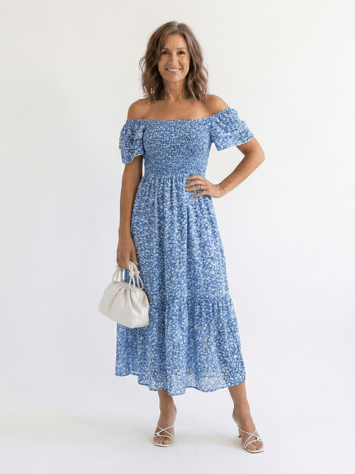 Emma & Rose Cape Town Odette™ floral smocked midi dress with ruffled sleeves and a fitted waist, featuring a colorful floral pattern.