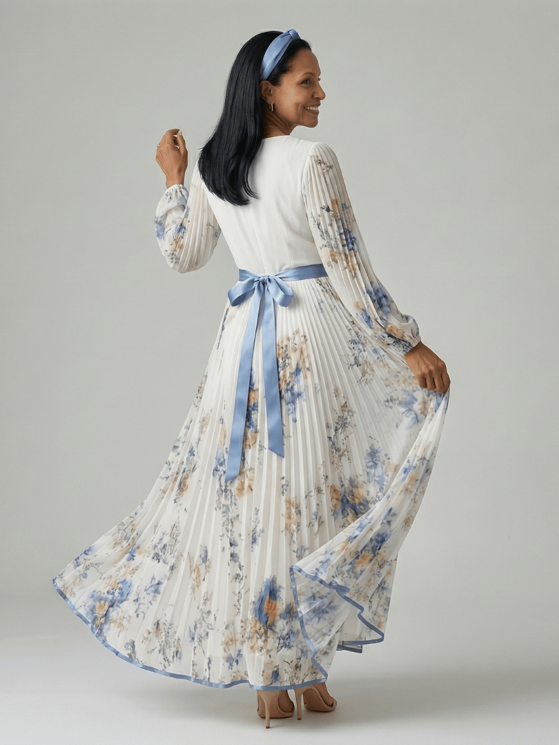 Emma & Rose Cape Town Rielle™ pleated wrap midi dress featuring a flowing skirt and elegant design on a model.