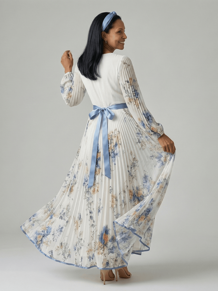 Emma & Rose Cape Town Rielle™ pleated wrap midi dress featuring a flowing skirt and elegant design on a model.