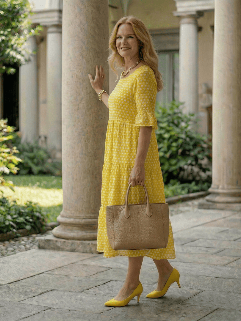 Emma & Rose Cape Town Arlo™ Dot Tiered Midi Dress, featuring a colorful patterned fabric and tiered design, displayed on a hanger.