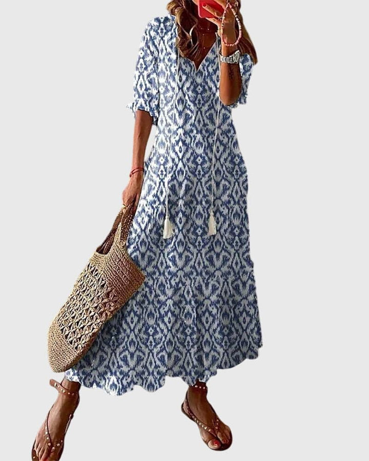 Emma & Rose Cape Town Amalia™ boho vintage summer dress with floral pattern and flowing fabric, perfect for warm weather.