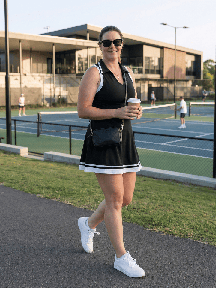 Emma & Rose Cape Town Calune™ collared tennis skirt dress featuring a fitted bodice and pleated skirt in vibrant athletic fabric.