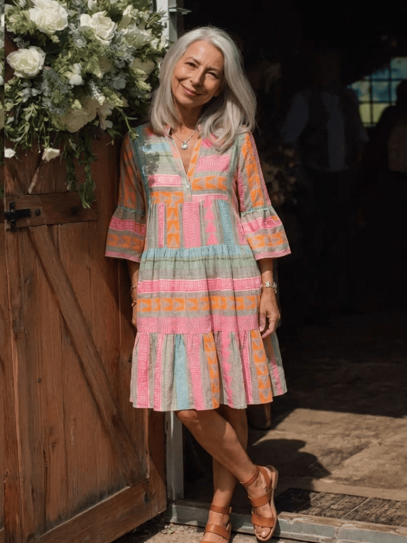 Maelle™ tiered knee-length dress by Emma & Rose Cape Town, flowing fabric with layered design and short sleeves.