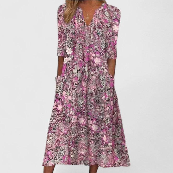 Queenie™ elegant summer dress by Emma & Rose Cape Town, featuring light fabric and floral design, displayed on a mannequin.