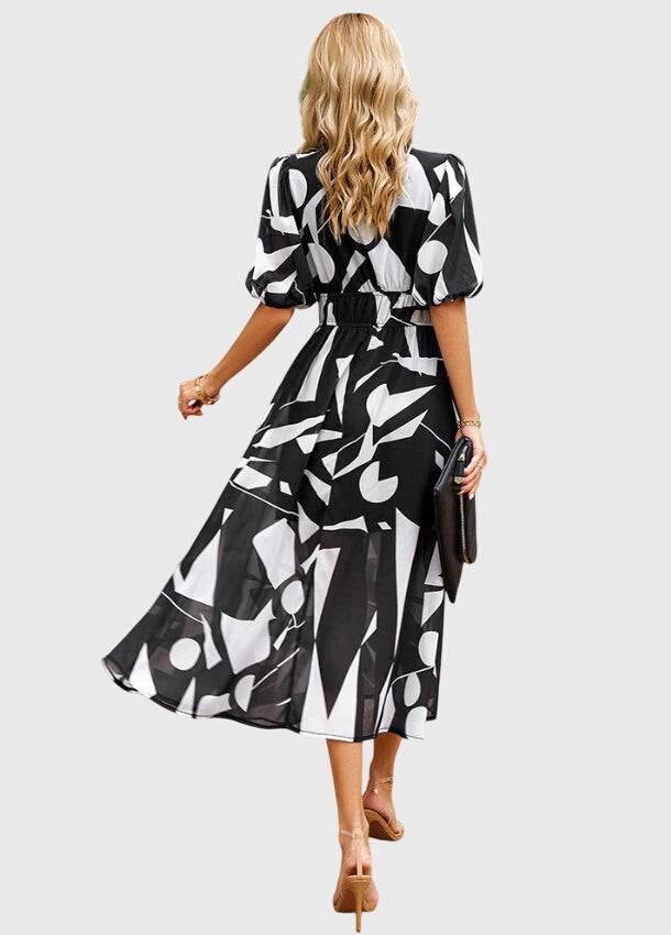 Emma & Rose Cape Town Merlin™ Estella floral midi dress with a flattering silhouette and vibrant floral pattern, shown on a model.