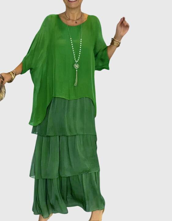 Elegant long flowing dress by Emma & Rose Cape Town, featuring a graceful silhouette and intricate fabric details.