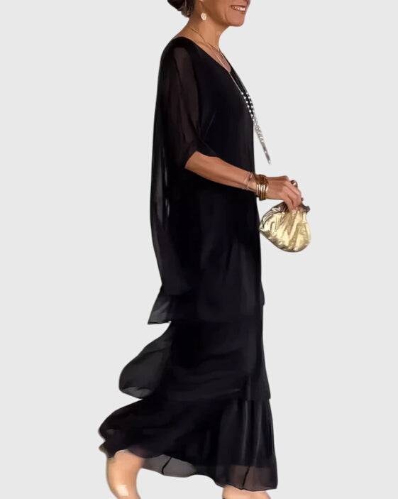 Susan™ long flowing elegant dress by Emma & Rose Cape Town, featuring a graceful, floor-length design with intricate fabric details.