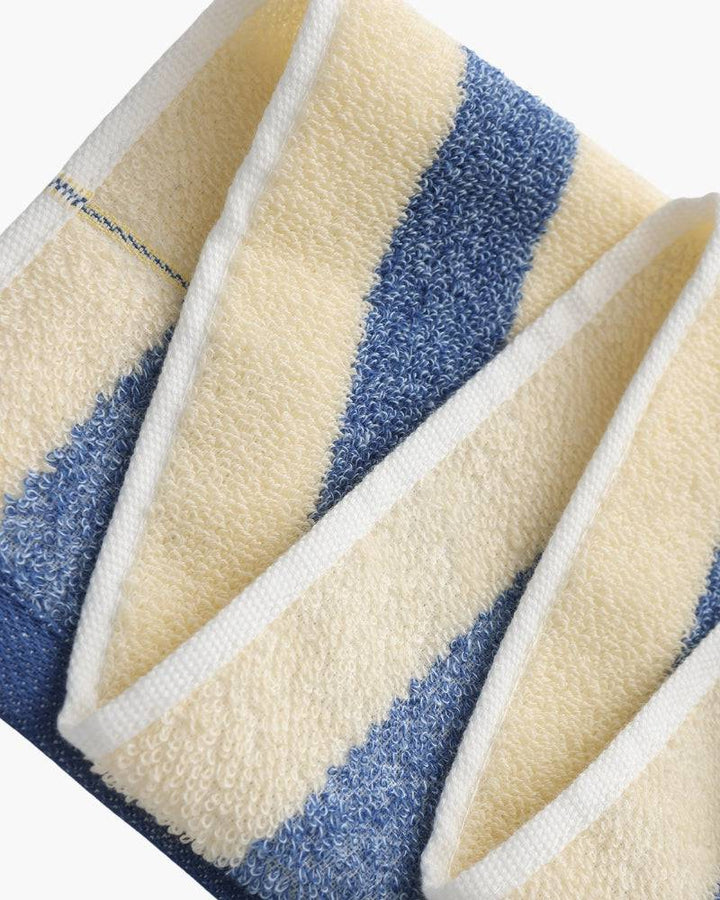 Emma & Rose Manhattan Lance™ Sea Stripe Hand Towel with blue and white nautical stripes, soft cotton fabric, hanging on a wooden hook.