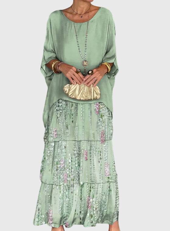 Long flowing elegant dress by Emma & Rose Cape Town, featuring a graceful design and soft fabric in a stunning style.