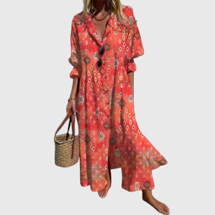 Zariah™ elegant bohemian dress by Emma & Rose Cape Town, flowing fabric with intricate patterns and relaxed fit, displayed on a hanger.