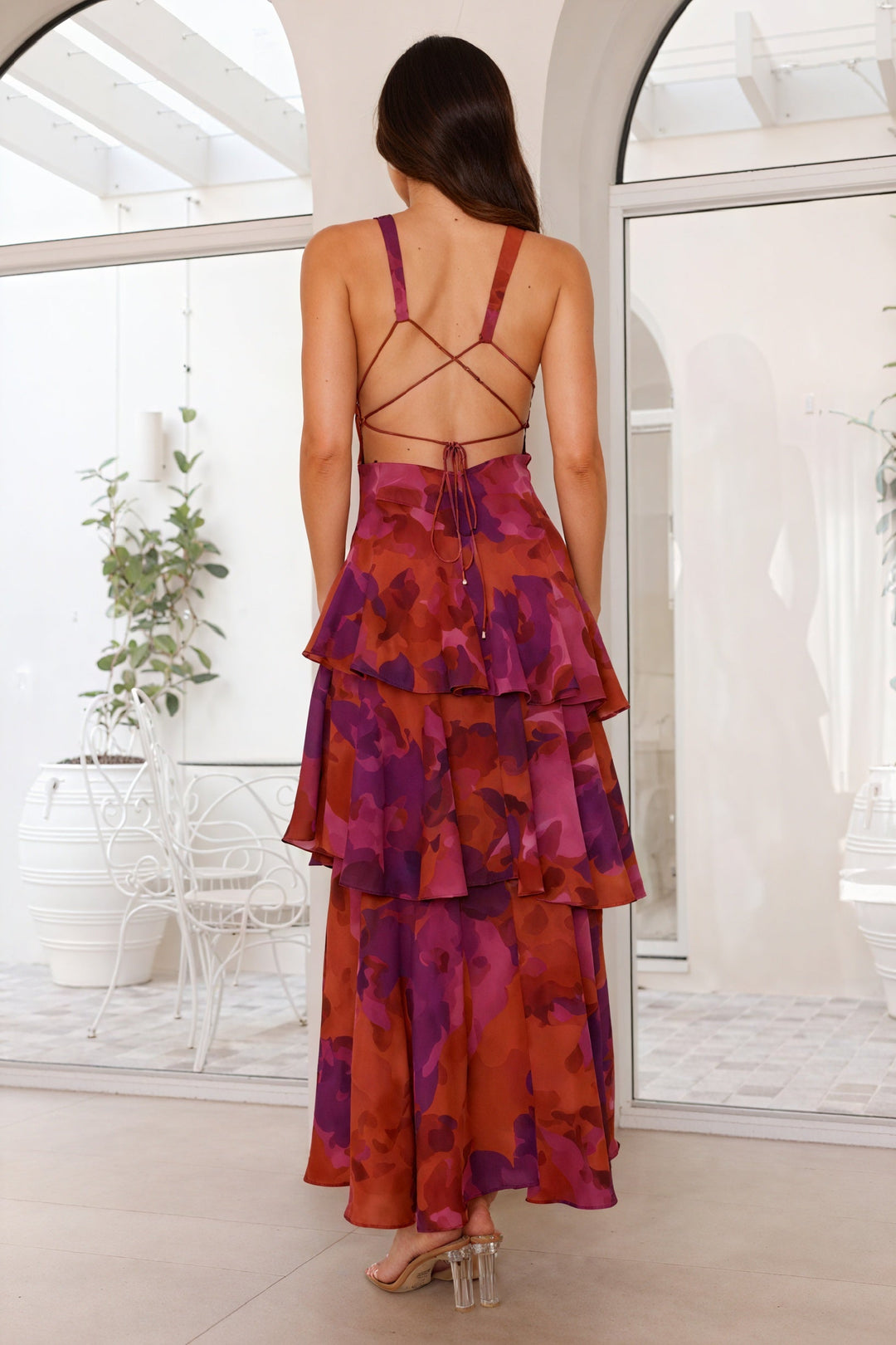 Floral print dress with deep V-neck by Emma & Rose Cape Town, featuring a flowing fabric and vibrant flower pattern.