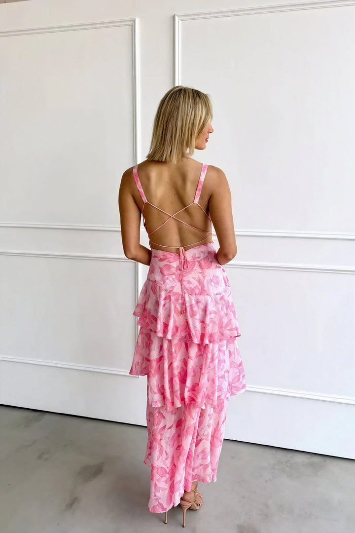 Floral print dress with deep V-neck by Emma & Rose Cape Town, featuring vibrant flower patterns and flowing fabric.
