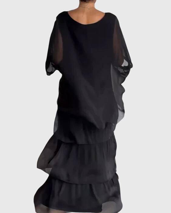 Long flowing elegant dress from Emma & Rose Cape Town featuring soft fabric and a graceful design, perfect for formal occasions.