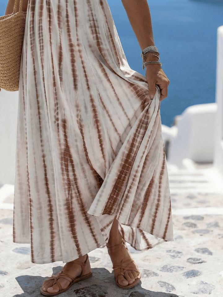 Karys™ soft dye midi dress by Emma & Rose Cape Town, showcasing a flowy, pastel-colored fabric with a fitted waist and elegant silhouette.