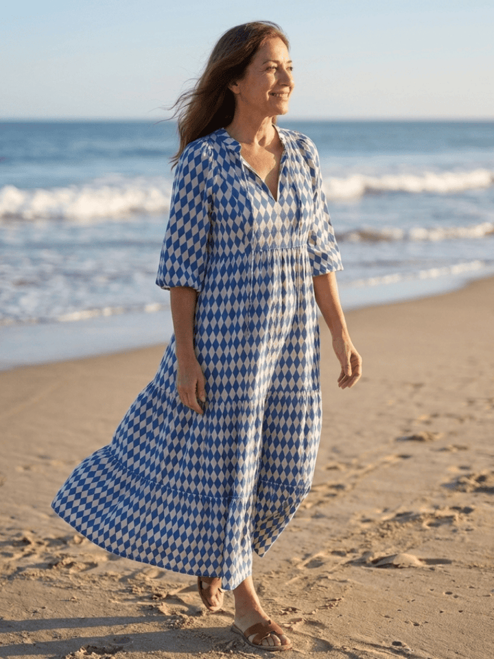 Elodie™ Print Tiered Midi Dress by Emma & Rose Cape Town featuring a colorful, flowing fabric and tiered design.