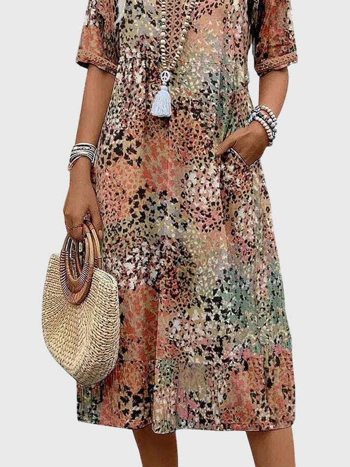 Elegant floral midi dress by Emma & Rose Cape Town featuring a flowing silhouette and intricate floral pattern.