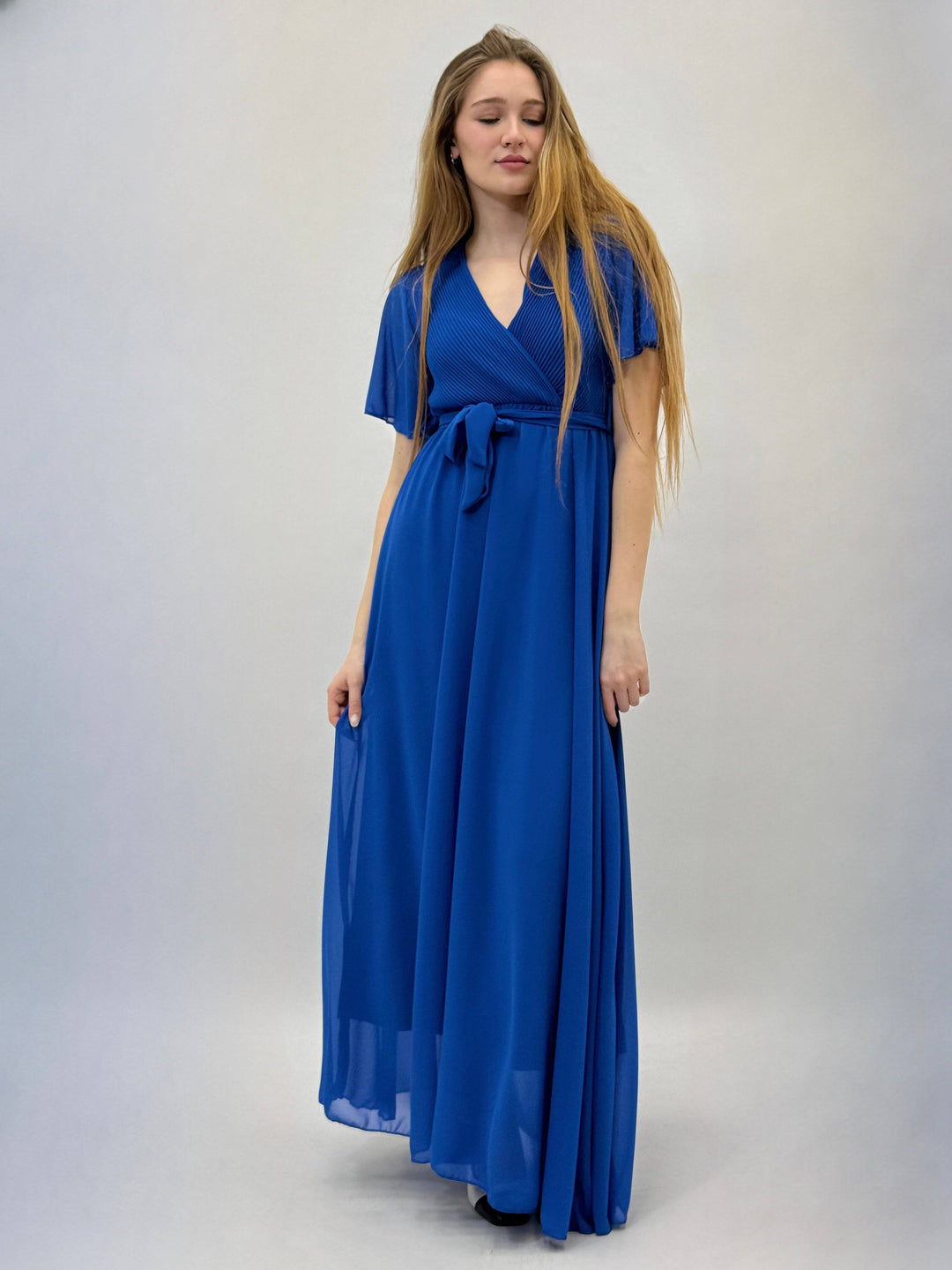 Emma & Rose Cape Town Margot™ flowing dress in soft fabric with elegant drape and long sleeves, displayed on a hanger.