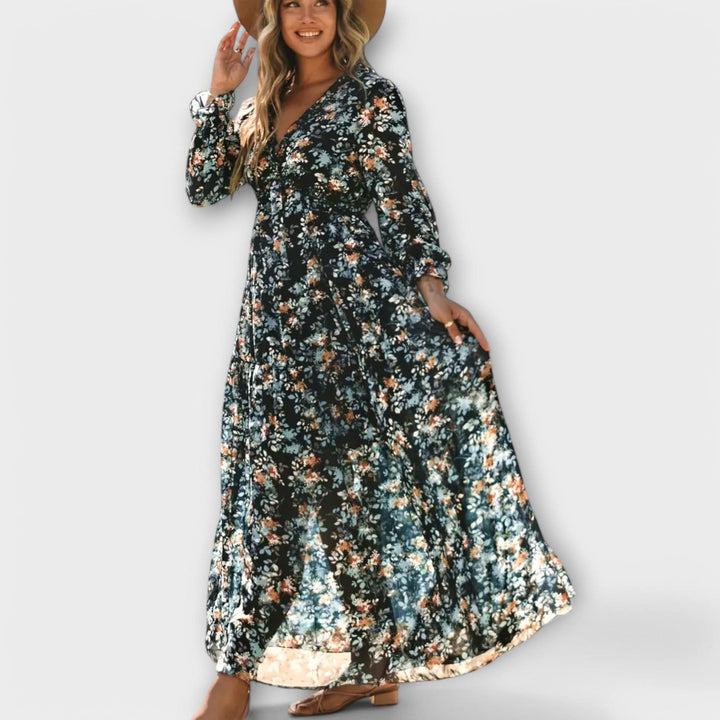 Ynah™ elegant maxi dress by Emma & Rose Cape Town displayed on a hanger with flowing fabric and intricate details.