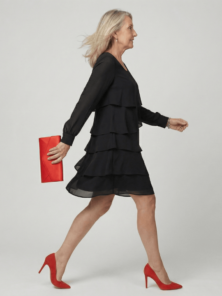 Emma & Rose Cape Town Kirax™ layered knee-length dress displayed on a model, featuring a stylish, flowy design with layered fabric.