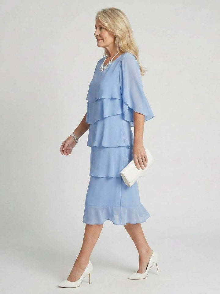 Emma & Rose Cape Town Brent™ layered tier midi dress featuring flowing fabric and tiered design, shown in soft pastel color.