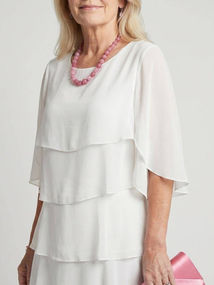 Emma & Rose Cape Town Brent™ layered tier midi dress displayed on a mannequin with flowing fabric and tiered design.