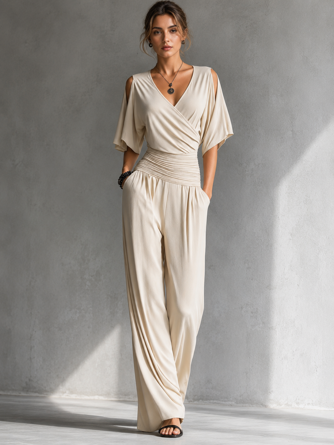 Elegant women's jumpsuit with a crossover V-neck and wide pants