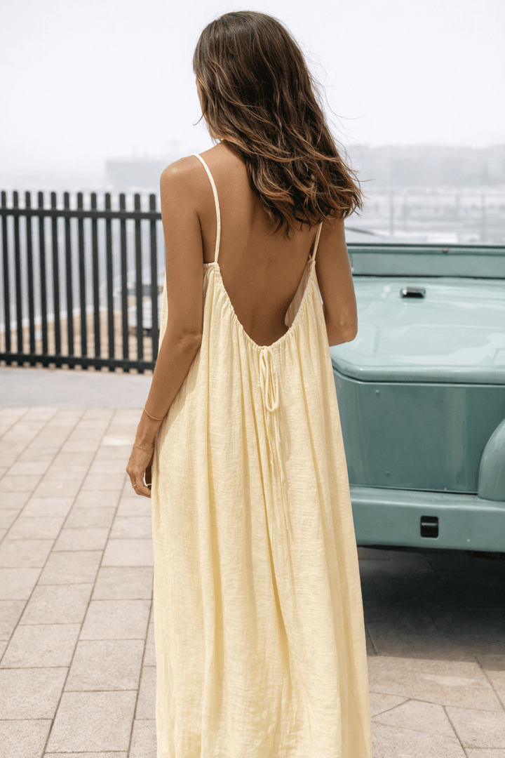 Emma & Rose Cape Town Mora™ Velle Noir backless maxi dress, flowing black fabric with elegant design and open back detail.