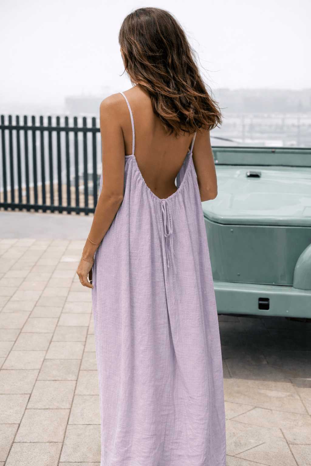 Velle Noir Mora™ backless maxi dress by Emma & Rose Cape Town displayed on a hanger with flowing fabric and elegant silhouette.