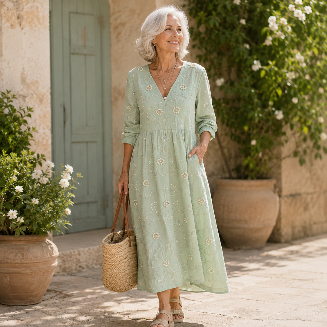 Floral midi dress by Emma & Rose Cape Town featuring a fitted bodice, flowing skirt, and vibrant flower pattern.
