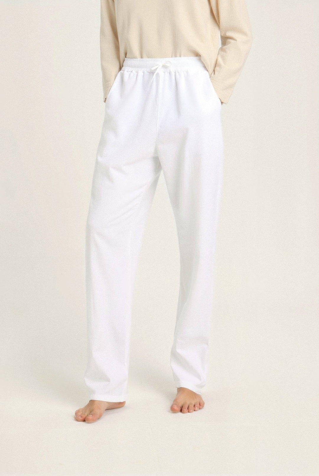 Flat lay of Emma & Rose Manhattan Wendy™ lightweight linen beach pants in natural beige, stylish and comfortable summer wear.