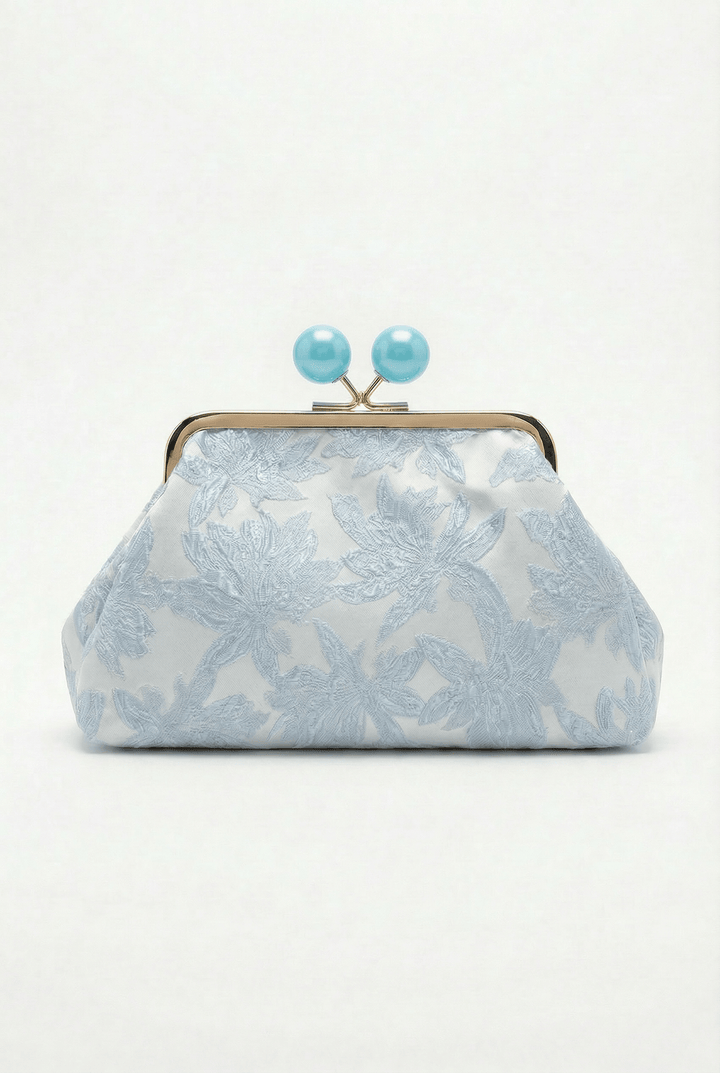 Simone™ elegant clutch bag closure by Emma & Rose Cape Town, featuring a polished, decorative clasp on a stylish black bag.