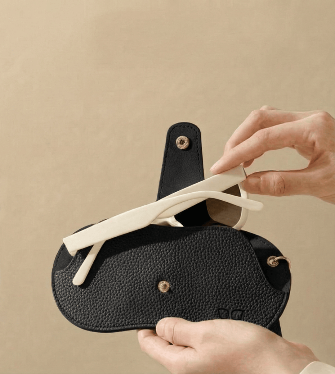 Emma & Rose Cape Town Winnie™ glasses case in black leather with embossed logo and rounded edges.