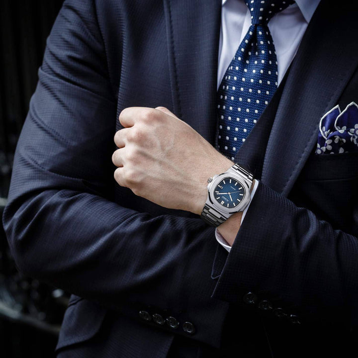Stainless steel watch from Roland™ by Emma & Rose Manhattan, featuring a sleek, modern design with a round face and metal band.