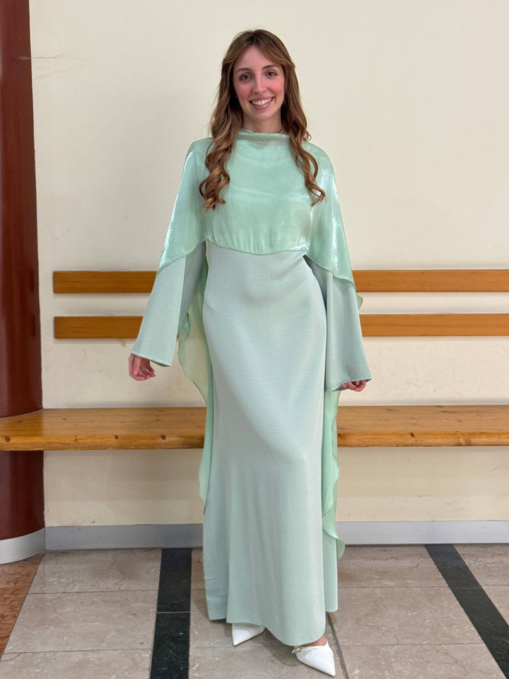 Elegant long dress cape by Mieke™ from Emma & Rose Cape Town, featuring flowing fabric and intricate detailing.