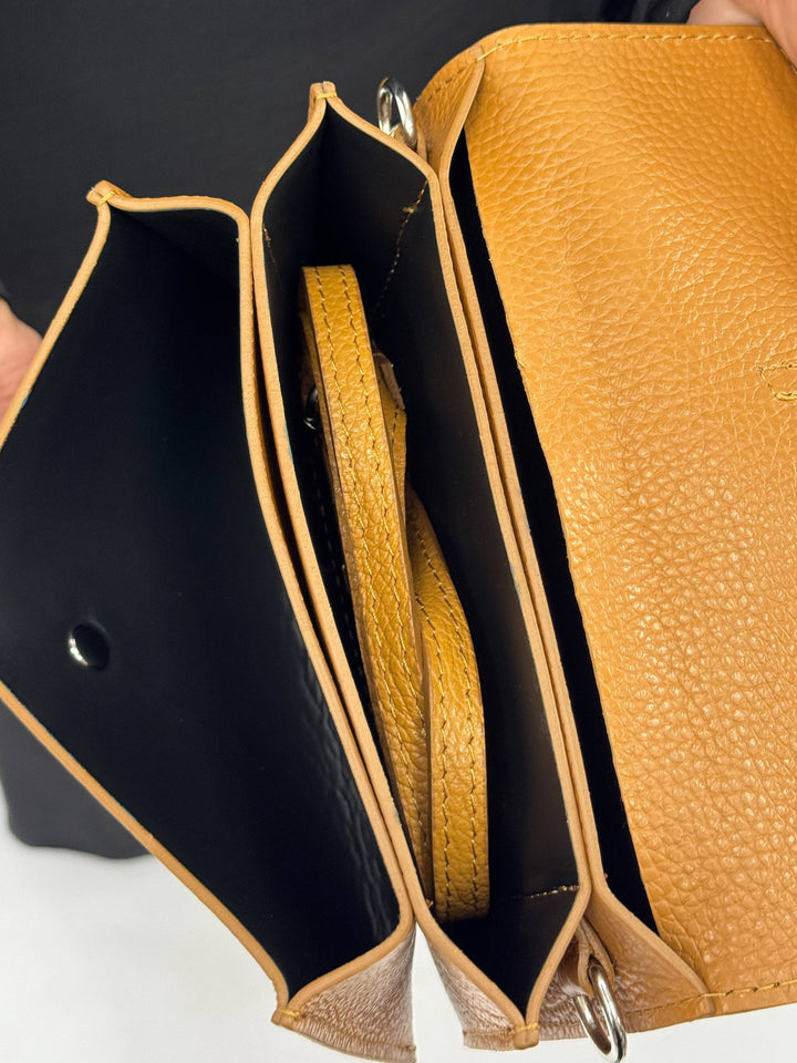 Emma & Rose Cape Town Yael™ leather clutch bag strap showing brown leather material and adjustable design.