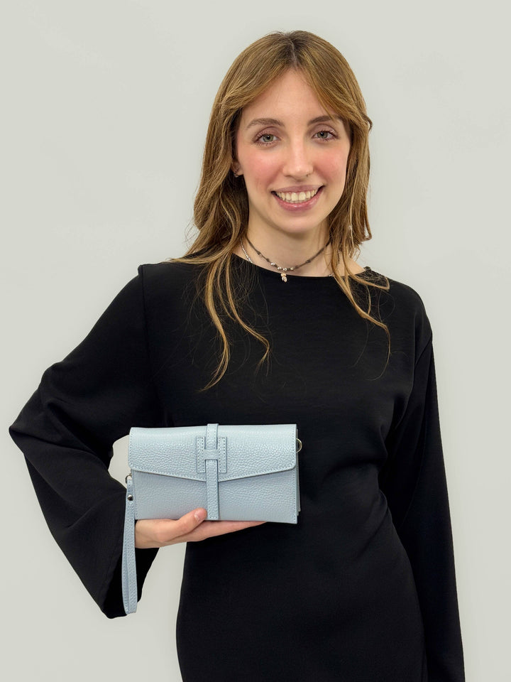 Emma & Rose Cape Town Yael™ leather clutch bag strap attached to a black clutch, showcasing its stylish, high-quality leather design.