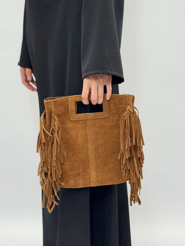 Emma & Rose Cape Town Elke™ suede leather bag with rounded shape, top handle, and subtle stitching details.